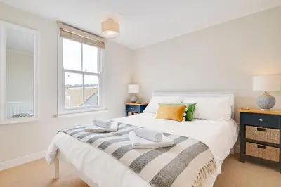a white bedroom with a bed and a window at 3 Bed in St. Ives oc-marhou in St Ives