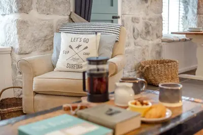 a living room with a coffee table and a chair at 2 Bed in St. Ives oc-minmar in St Ives