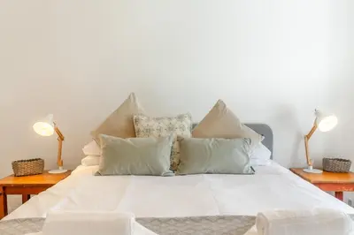 a bed with white sheets and pillows on it at 2 Bed in St. Ives oc-minmar in St Ives