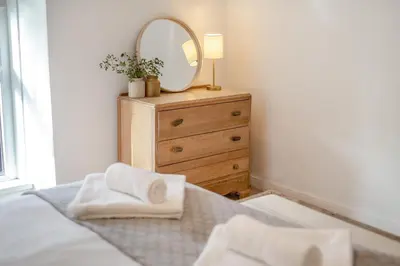 a bedroom with a bed with a mirror and a dresser at 2 Bed in St. Ives oc-minmar in St Ives