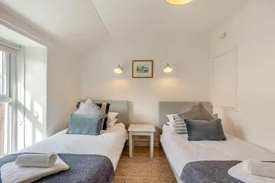 two beds in a room with a window at 2 Bed in St. Ives oc-minmar in St Ives
