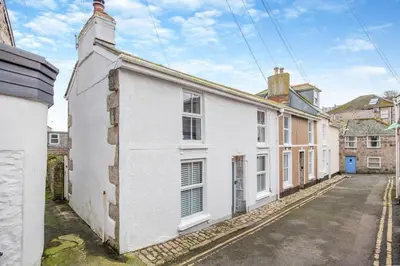an old white house with a street in front of it at 2 Bed in St. Ives oc-minmar in St Ives