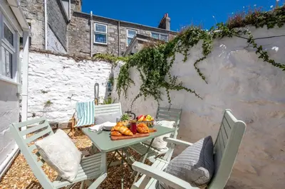a table and chairs with a plate of fruit on it at 2 Bed in St. Ives oc-minmar in St Ives