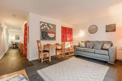 a living room with a couch and a table at 1 Bed in St Ives oc-nic01 in St Ives