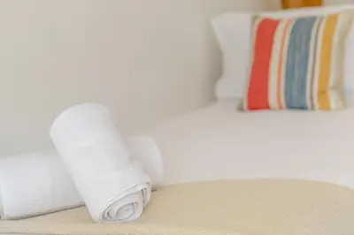 a stack of white towels sitting on a bed at 2 Bed in St Ives oc-nic24 in St Ives