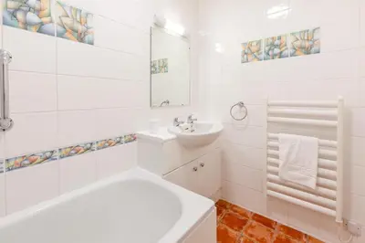 a white bathroom with a sink and a bath tub at 2 Bed in St Ives oc-nic24 in St Ives