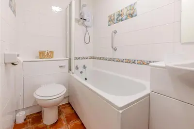 a white bathroom with a toilet and a sink at 2 Bed in St Ives oc-nic24 in St Ives