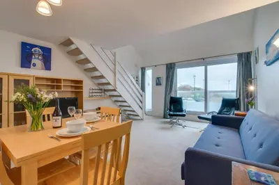 a living room with a table and a blue couch at 1 Bed in St Ives oc-nicc41 in St Ives