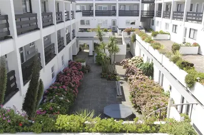 an apartment building with a courtyard with flowers and plants at 1 Bed in St Ives oc-nicc41 in St Ives