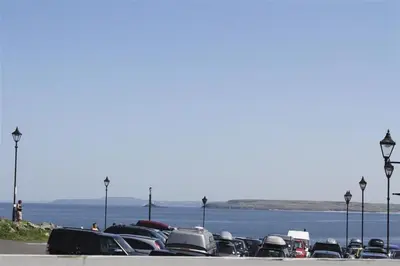 a parking lot with cars parked next to the water at 1 Bed in St Ives oc-nicc41 in St Ives