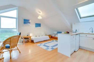 a kitchen and a living room with a table at 1 Bed in St Ives oc-nic48 in St Ives