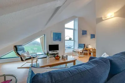 a living room with a blue couch and a table at 1 Bed in St Ives oc-nic48 in St Ives