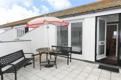a patio with a table and two chairs and an umbrella at 1 Bed in St Ives oc-nic48 in St Ives