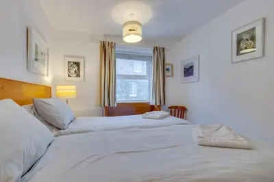 two twin beds in a bedroom with a window at 1 Bed in St Ives oc-nic049 in St Ives