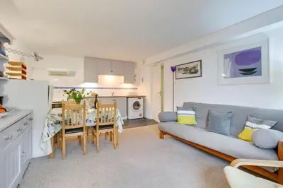 a kitchen and living room with a couch and a table at 1 Bed in St Ives oc-nic049 in St Ives