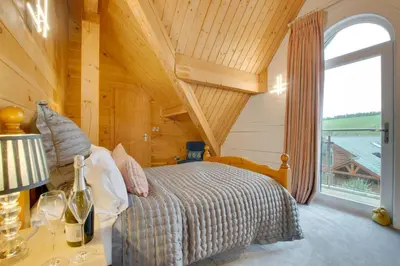 a bedroom with a bed and a large window at 4 Bed in Wadebridge oc-p00066 in Little Petherick