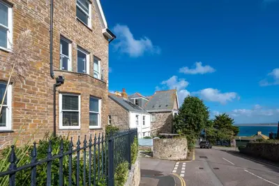a brick house with a fence next to a street at 2 Bed in St Ives oc-pedtc1 in St Ives