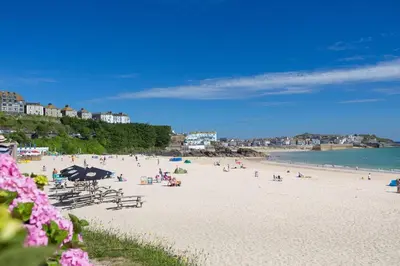 a beach with people on the sand and the water at 2 Bed in St Ives oc-pedtc1 in St Ives