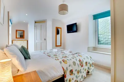 a white bedroom with a bed and a window at 2 Bed in St Ives oc-pmho08 in St Ives