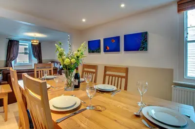 a dining room with a wooden table and chairs at 2 Bed in St Ives oc-pmho08 in St Ives