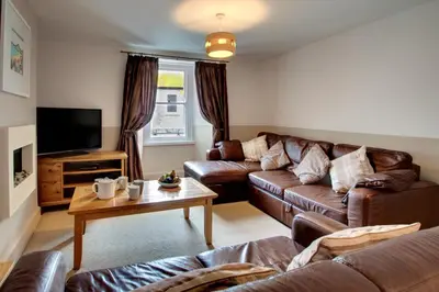 a living room with leather couches and a tv at 2 Bed in St Ives oc-pmho08 in St Ives
