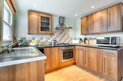 a kitchen with wooden cabinets and a sink at 2 Bed in St Ives oc-pmho08 in St Ives