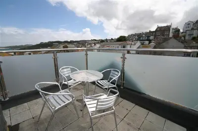 a balcony with a table and chairs on a roof at 2 Bed in St Ives oc-pmho10 in St Ives