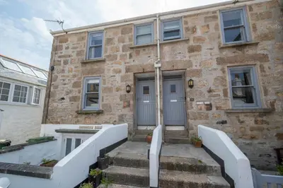 a stone house with a staircase leading to the door at 2 Bed in St Ives oc-pmho10 in St Ives