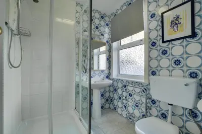 a bathroom with a shower and a sink and a toilet at 1 Bed in St Ives oc-quayst in St Ives