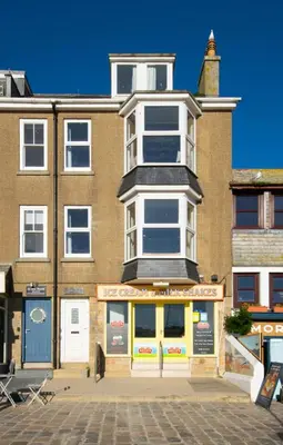 a building with a store in front of it at 1 Bed in St Ives oc-quayst in St Ives