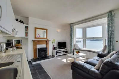 a kitchen and living room with a couch and a fireplace at 1 Bed in St Ives oc-quayst in St Ives