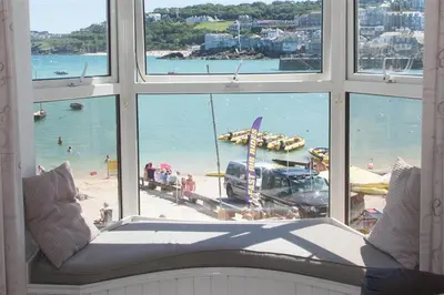 a window with a view of a beach and the ocean at 1 Bed in St Ives oc-quayst in St Ives