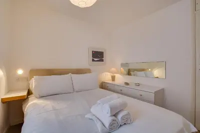 a bedroom with a white bed with towels on it at 2 Bed in St Ives oc-redc4 in St Ives