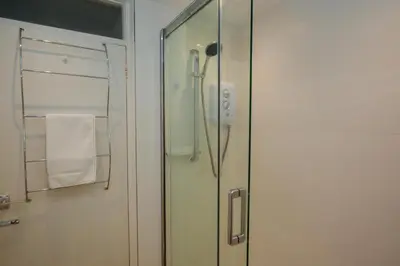 a shower in a bathroom with a glass door at 2 Bed in St Ives oc-redc4 in St Ives