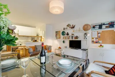 a living room with a glass table with a bottle of wine at 2 Bed in St Ives oc-redc4 in St Ives