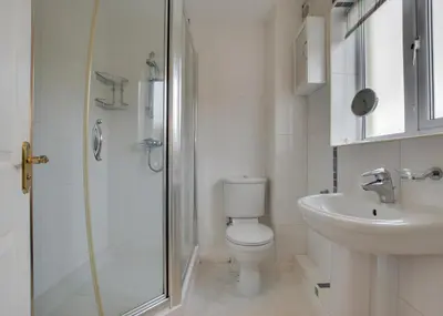 a bathroom with a shower and a toilet and a sink at 3 Bed in Porthleven oc-rosen in St Ives