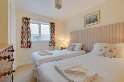 a bedroom with two beds and a window at 3 Bed in Porthleven oc-rosen in St Ives