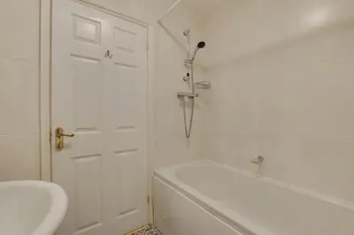 a bathroom with a tub and a toilet and a sink at 3 Bed in Porthleven oc-rosen in St Ives