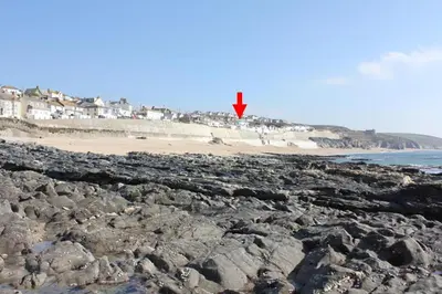 a red kite flying over a rocky beach at 3 Bed in Porthleven oc-rosen in St Ives