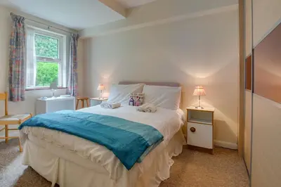a bedroom with a bed and two lamps and a window at 1 Bed in St Ives oc-seacft in St Ives