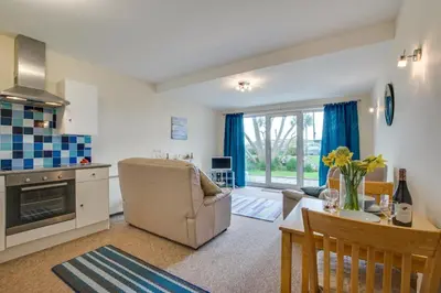 a kitchen and living room with a table and a couch at 1 Bed in St Ives oc-seacft in St Ives