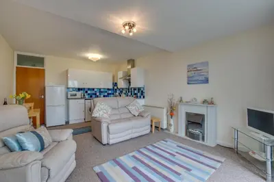 a living room with a couch and a kitchen at 1 Bed in St Ives oc-seacft in St Ives