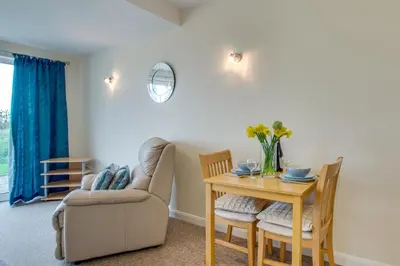 a living room with a table and a couch at 1 Bed in St Ives oc-seacft in St Ives