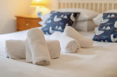 a group of rolled towels on a bed at 2 Bed in St Ives oc-shell in St Ives