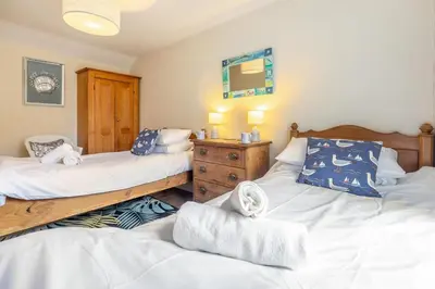 a bedroom with two beds and a wooden dresser at 2 Bed in St Ives oc-shell in St Ives
