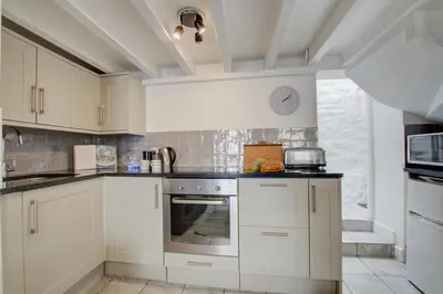 a kitchen with white cabinets and a sink at 2 Bed in St Ives oc-stg019 in St Ives