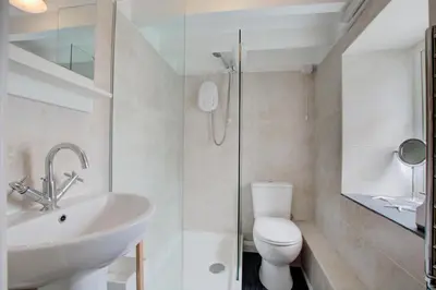 a bathroom with a sink and a toilet and a shower at 2 Bed in St Ives oc-stg019 in St Ives