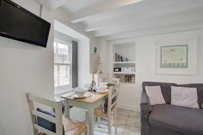 a living room with a table and a couch at 2 Bed in St Ives oc-stg019 in St Ives