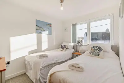 two beds in a room with a window at 2 Bed in Carbis Bay oc-t27418 in Carbis Bay