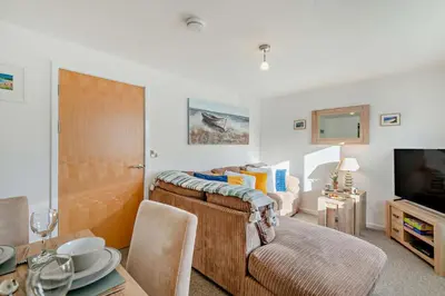 a bedroom with a bed and a table with a dining room at 2 Bed in Carbis Bay oc-t27418 in Carbis Bay